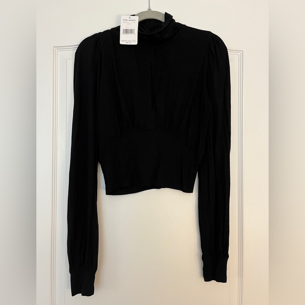 Free People long sleeve turtle neck shirt! Peep hole on the front! Never worn!
